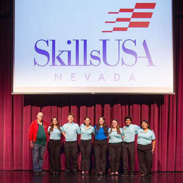 Seven students and an instructor on stage during the SkillsUSA conference.
